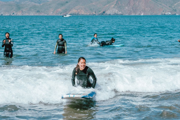 group of surfers in whitewash